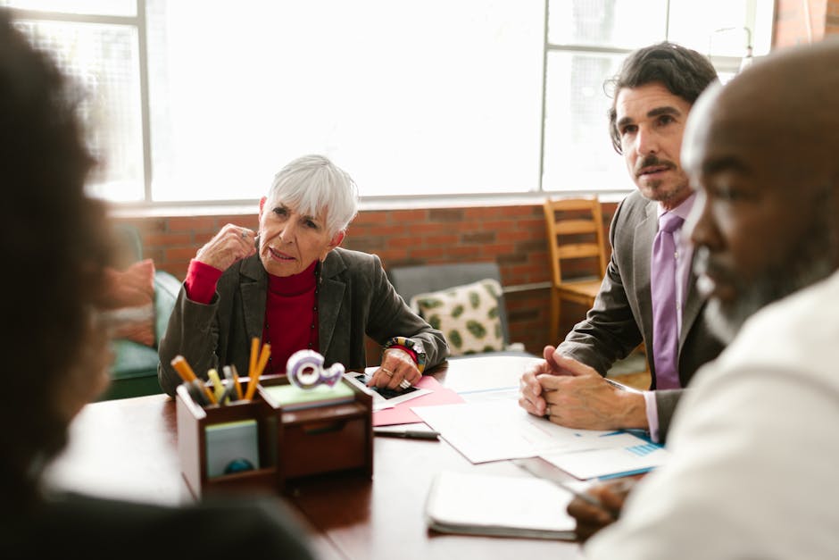 A group of professionals engaging in a collaborative meeting in a contemporary office setting